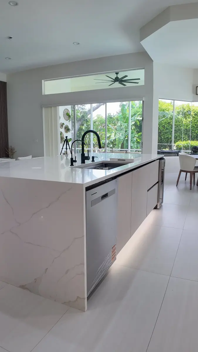 Island side view showing a built-in dishwasher and clear walkway space around the island