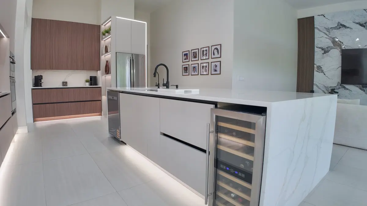 Kitchen island with a built-in wine refrigerator and cabinet storage